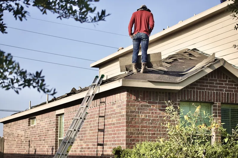 Professional roofer working on a residential roof in Gulls Hollow